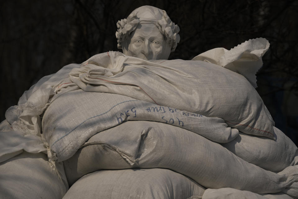 The statue of Italian poet and philosopher Dante Alighieri is almost covered with sandbags to protect it from potential damage from shelling, in Kyiv, Ukraine,Wednesday, March 23, 2022. (AP Photo/Vadim Ghirda)