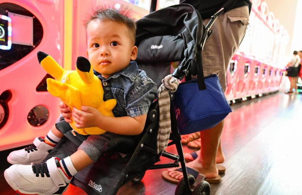 Hiro Vang, 16-months, of Fresno clutches to a Pikachu plush toy his father won for him at Claw Daddy arcade at Fashion Fair in Fresno on Tuesday, Aug. 22, 2023.