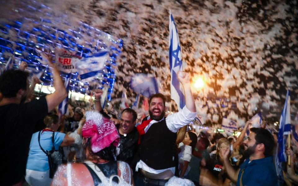 Israelis celebrate the swearing in of the new government in Tel Aviv, Israel - AP/AP