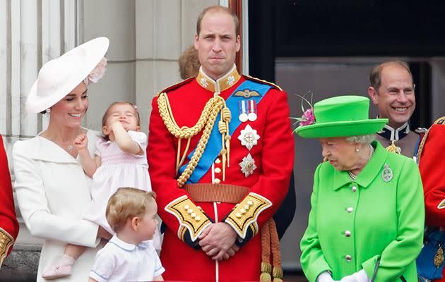 Prince William looks straight ahead after getting scolded while Prince George looks inquisitively at the Queen.