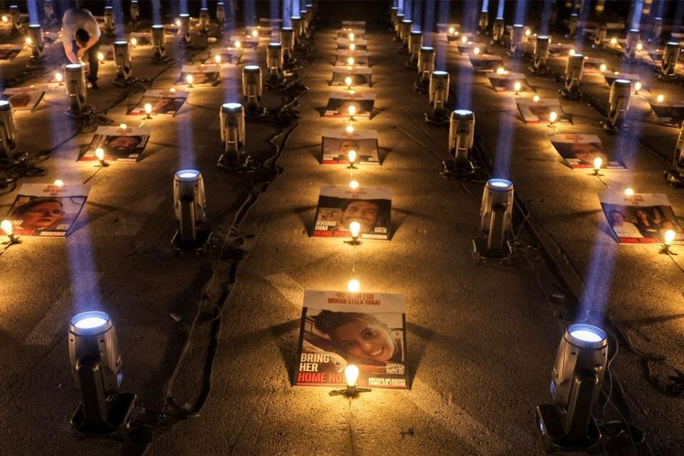 A light installation featuring images of hostages held by Hamas