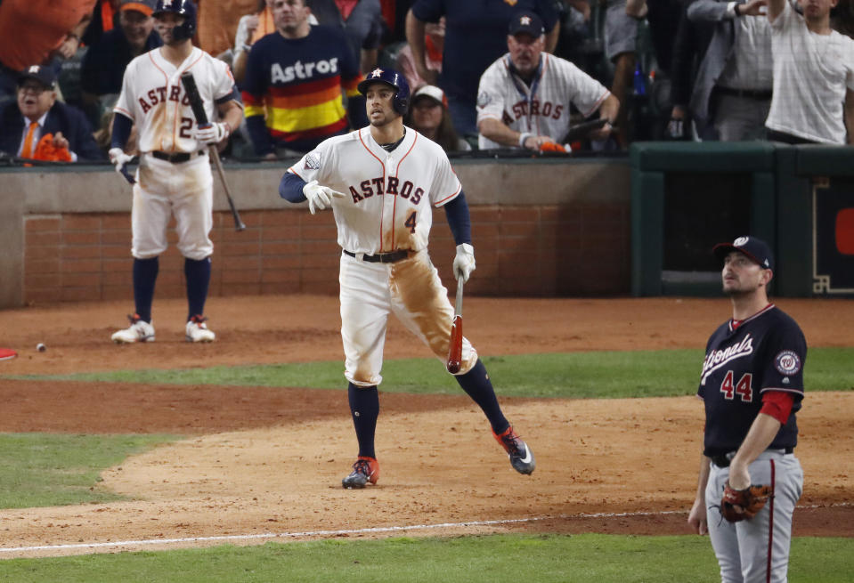 HOUSTON, TEXAS - OCTOBER 22:  George Springer #4 of the Houston Astros hits an RBI double against the Washington Nationals during the eighth inning in Game One of the 2019 World Series at Minute Maid Park on October 22, 2019 in Houston, Texas. (Photo by Tim Warner/Getty Images)