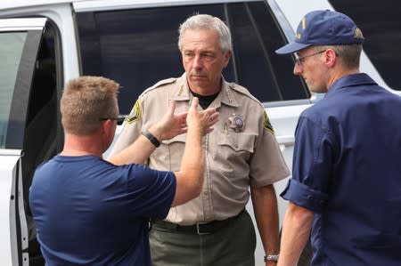 Mark Pazin, head the California Governor's Office of Emergency Services Law Enforcement Branch speaks with a colleague and an officer from the U.S. Coast Guard in Santa Barbara
