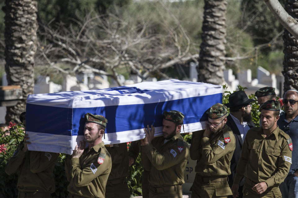 Comrades of killed Israeli soldier Staff Sgt. Yovel Mor Yosef carry his coffin during his funeral in Ashkelon, Israel, Friday, Dec. 14, 2018. Yosef was one of two Israeli soldiers killed by Palestinian gunman in the West Bank Thursday, Israel, Friday, Dec. 14, 2018. (AP Photo/Tsafrir Abayov)