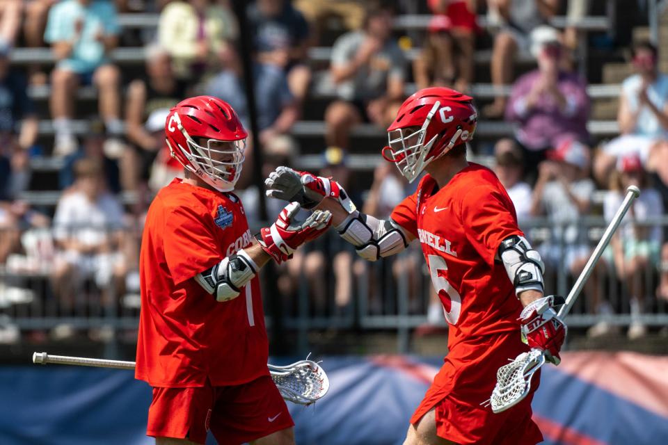 Cornell attack Michael Long (1) and Cornell attack CJ Kirst (15) celebrate a goal in the fourth quarter during the 2022 Division I men's lacrosse championship at Pratt & Whitney Stadium in East Hartford, Connecticut.