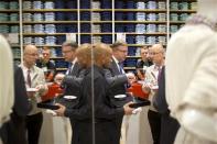 People stand in the Uniqlo Global flagship store during a preopening in Berlin, April 10, 2014. REUTERS/Axel Schmidt