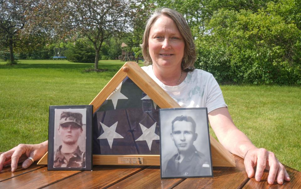 Ramona McGuire shows a portrait of her dad, Almus B. McGuire, at her home in Muskego. Mona McGuire enlisted in the Army to feel closer to her father, a former military police officer who died when she was 7.