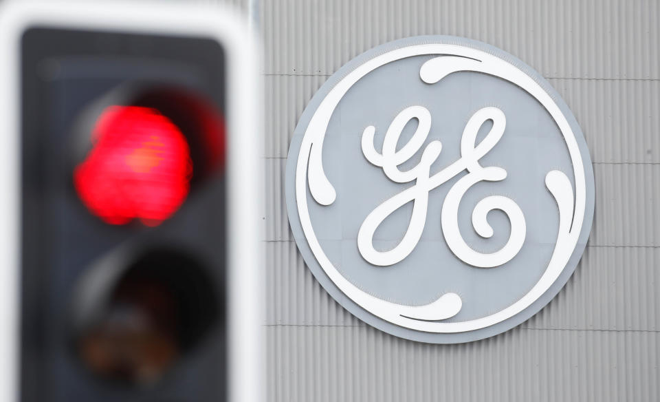 A traffic light is seen in front of a logo of General Electric at the company's plant in Birr, Switzerland June 17, 2019. REUTERS/Arnd Wiegmann