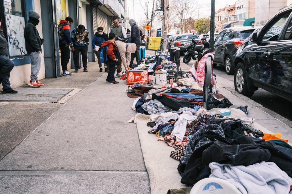 Migrant sidewalk vendors peddle goods shoplifted from retail stores just steps away on Roosevelt Avenue. Stephen Yang