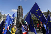 Anti Brexit demonstrators wave European Union flags outside Parliament in London, Tuesday, Oct. 22, 2019.British lawmakers from across the political spectrum were plotting Tuesday to put the brakes on Prime Minister Boris Johnson's drive to push his European Union divorce bill through the House of Commons in just three days, potentially scuttling the government's hopes of delivering Brexit by Oct. 31.(AP Photo/Kirsty Wigglesworth)