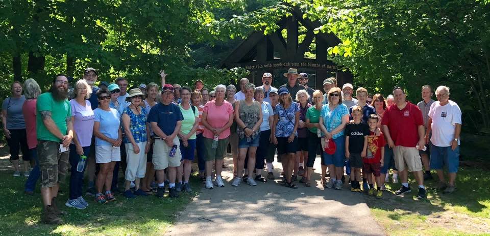 The Suburban Soles event series in South Milwaukee offers free guided walks through Grant Park with experts in various fields from plants and fungi to history. This group photo was taken in 2018 for the South Milwaukee Takes Root event.