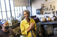 Fredrika Newton, widow of Black Panther Party co-founder Huey Newton, speaks with patina artist Aiya Jordan at Artworks Foundry on Tuesday, Aug. 10, 2021, in Berkeley, Calif. The bust is scheduled to be unveiled in Oakland on Sunday, Oct. 24, the first permanent public art piece honoring the party in the city of its founding. (AP Photo/Noah Berger)