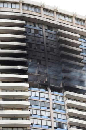 The Marco Polo apartment building after a fire broke out in it in Honolulu, Hawaii, July 14, 2017. REUTERS/Hugh Gentry