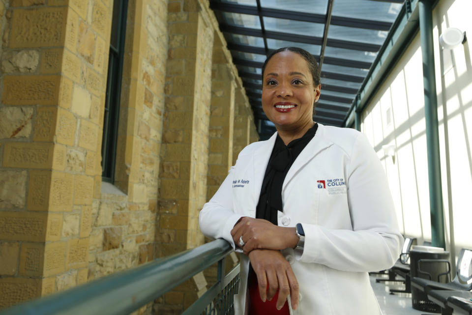 Dr. Mysheika W. Roberts, the health commissioner for Columbus Public Health, poses for a portrait in Columbus, Ohio, on Wednesday, April 14, 2021. Public health officials who have juggled bare-bones budgets for years are happy to have the additional money prompted by the COVID-19 pandemic. Yet they worry it will soon dry up as the pandemic recedes, continuing a boom-bust funding cycle that has plagued the U.S. public health system for decades. If budgets are slashed again, they warn, that could leave the nation where it was before covid: unprepared for a health crisis. “We need funds that we can depend on year after year,” says Roberts. (AP Photo/Paul Vernon)