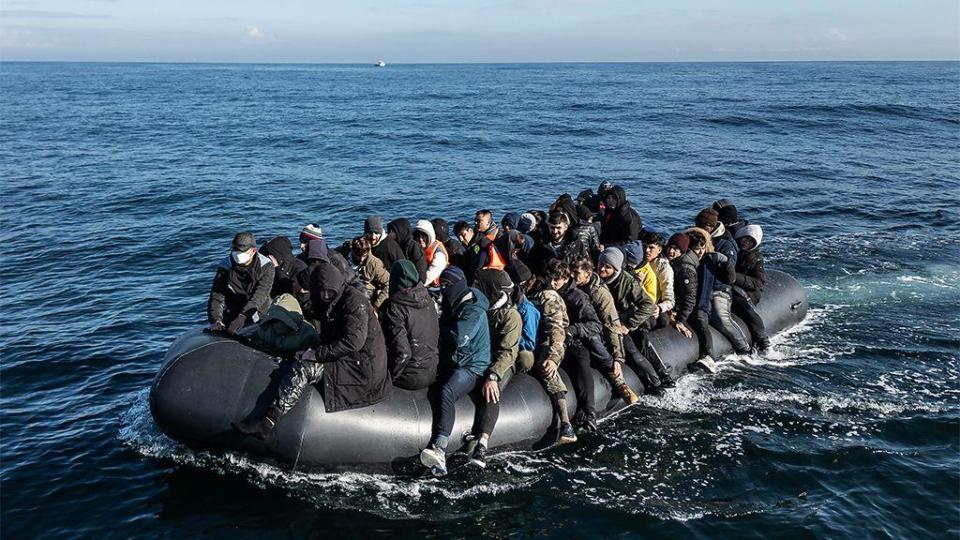 A dinghy carrying around 65 migrants crosses the English Channel