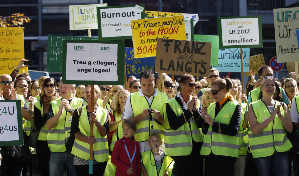 Lufthansa cabin crew members gather for a demonstration as flight attendants of German Lufthansa airline went on an 24-hour-strike for higher wages at the airport in Munich, southern Germany, on Friday, Sept. 7, 2012. Poster at center reads "Franz it's enough now" in reference to Lufthansa's CEO Christoph Franz. (AP Photo/Matthias Schrader)