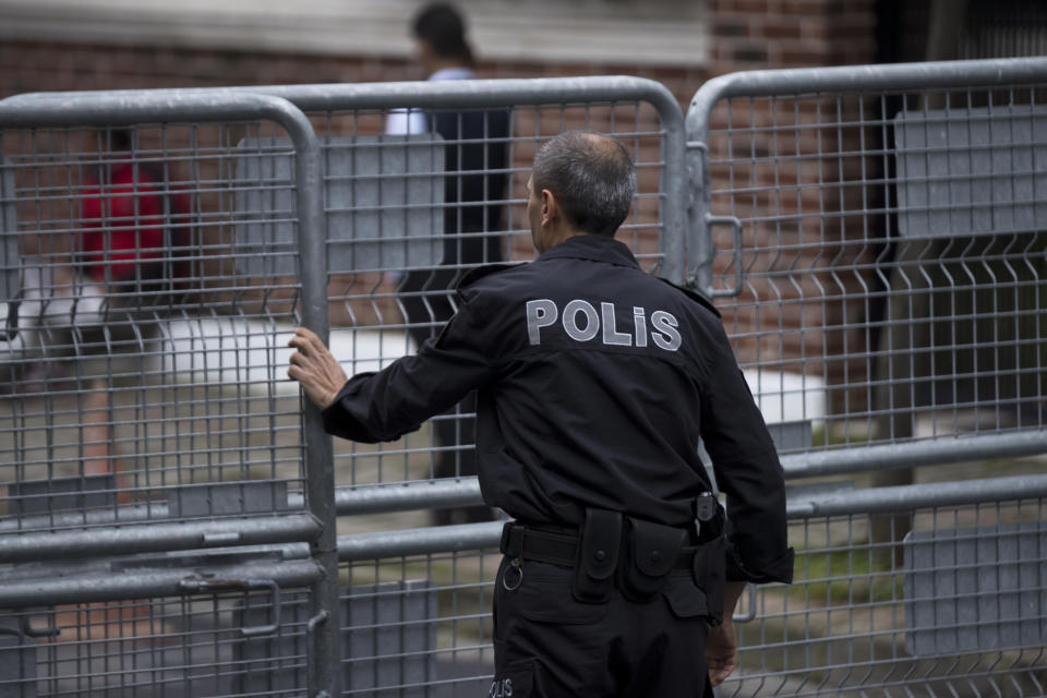 A Turkish police officer secures the entrance to Saudi Arabia's consulate in Istanbul, Sunday, Oct. 14, 2018. Veteran Saudi journalist Jamal Khashoggi disappeared over a week ago while on a visit to the Saudi Consulate in Istanbul, sparking an international uproar involving the kingdom, Turkey and the United States that remains unresolved. (AP Photo/Petros Giannakouris)