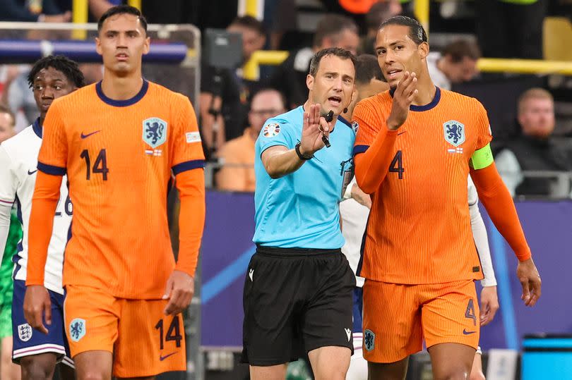 Virgil van Dijk speaks to referee Felix Zwayer during the Euro 2024 semi-final between England and the Netherlands