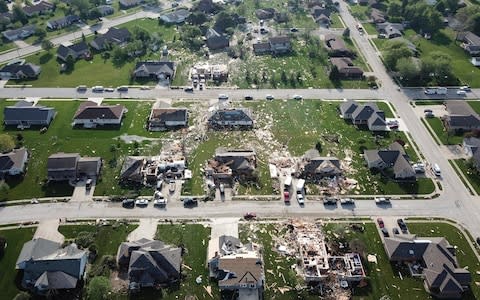 An aerial photo shows damaged homes and debris marking the path of a tornado in Celina - Credit: AP