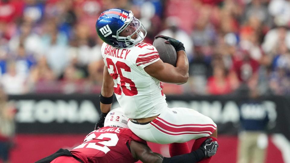 Sep 17, 2023; Glendale, Arizona, USA; Arizona Cardinals safety K'Von Wallace (22) tackles New York Giants running back Saquon Barkley (26) during the first half at State Farm Stadium. Mandatory Credit: Joe Camporeale-USA TODAY Sports