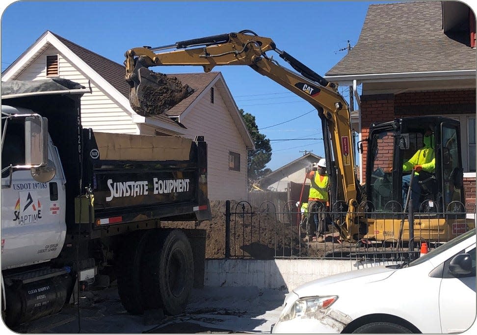 Cleanup crews are shown here outside a residential property in the Colorado Smelter Superfund Site.