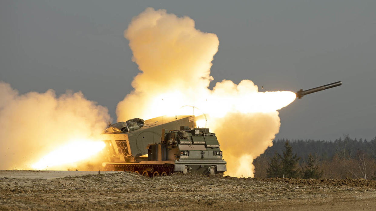 Army soldiers fire a rocket from an M270 multiple launch rocket system.