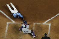 Tampa Bay Rays' Manuel Margot is tagged out at home by Los Angeles Dodgers catcher Austin Barnes trying to steal during the fourth inning in Game 5 of the baseball World Series Sunday, Oct. 25, 2020, in Arlington, Texas. (AP Photo/David J. Phillip)