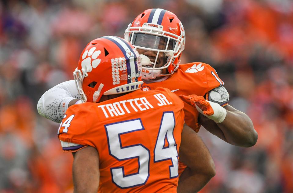 Clemson defensive tackle Tyler Davis (13) celebrates after teammate linebacker Jeremiah Trotter Jr. (54) sacks Miami quarterback Jacurri Brown (11) during the first quarter at Memorial Stadium in Clemson, South Carolina Saturday, Nov. 12, 2022.   