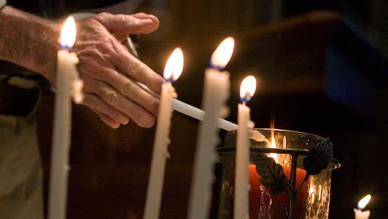 Vaughn Lovejoy lights a candle during the second annual Day of Remembrance for Utah Downwinders at the Skaggs Memorial Chapel, First Baptist Church of Salt Lake City on Jan. 27, 2013.