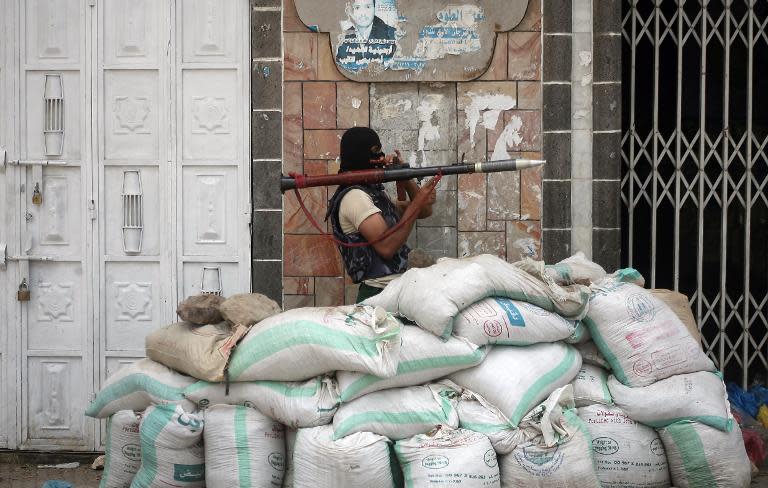 An armed Yemeni tribal gunman from the Popular Resistance Committees loyal to fugitive President Abedrabbo Mansour Hadi, readies his weapon on May 24, 2015 during clashes with Shiite Huthi rebels in the city of Taez