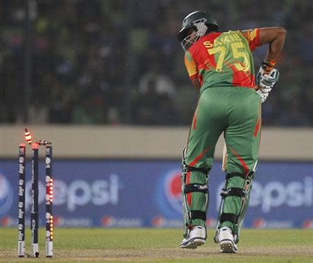 Bangladesh's Shakib Al Hasan is bowled out against India during their ICC Twenty20 World Cup match at the Sher-E-Bangla National Cricket Stadium in Dhaka March 28, 2014. REUTERS/Andrew Biraj