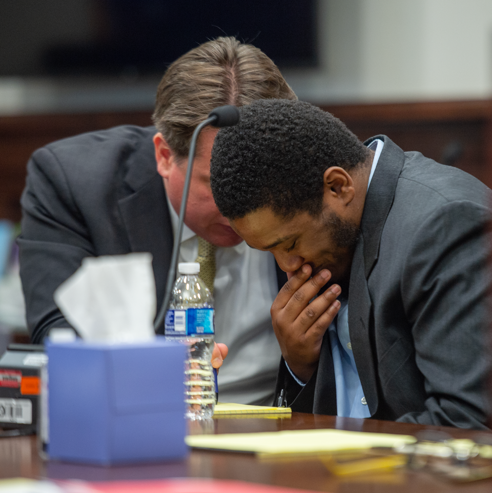 Thomas Ellis, right, listens to attorney Adam VanHo before opening statements Tuesday in Summit County Common Pleas Court in Akron.