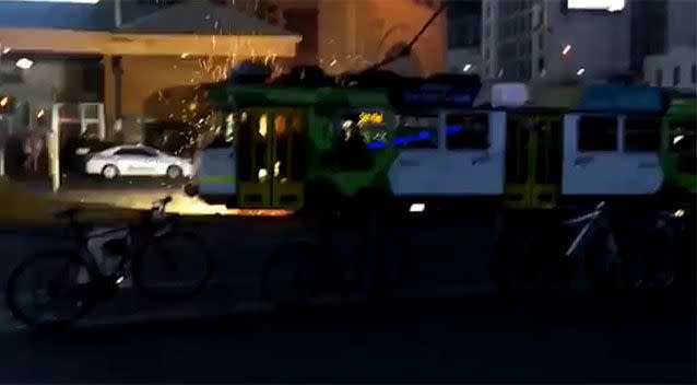 Sparks shot out of the front of the tram while it was travelling down Flinders Street in Melbourne's CBD. Photo: YouTube