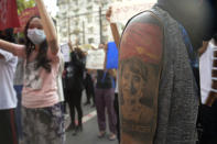 A protester with an image of ousted Myanmar leader Aung San Suu Kyi on the arm joins anti-coup protest march in Yangon, Myanmar, Saturday, April 10, 2021. Security forces in Myanmar cracked down heavily again on anti-coup protesters Friday even as the military downplayed reports of state violence.(AP Photo)