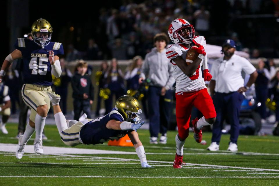 Smyrna's Andre Ashley beats a last-ditch tackle attempt by Salesianum's Mitchell Cummings and scores to give the Eagles a 40-35 lead with 2:20 to play in Salesianum's 41-40 win in the first round of the DIAA Class 3A tournament, Friday, Nov. 17, 2023 at Abessinio Stadium.