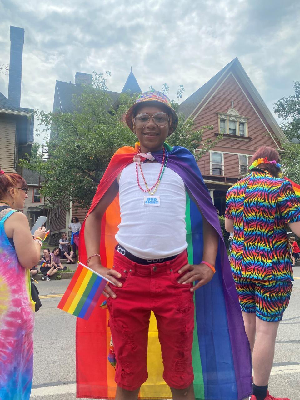 Payton Barnes, who wore a rainbow flag like a super hero cape at the 2023 Rochester Pride Parade, is a gay Black man living in Rochester. Sometimes that’s easy, like  at the July 15 parade, when Barnes was surrounded by cheering LGBTQ people and allies in broad daylight along a city street. Other days, it’s less easy, and there are fewer places to be free. But you have to be you, no matter what, Barnes said.