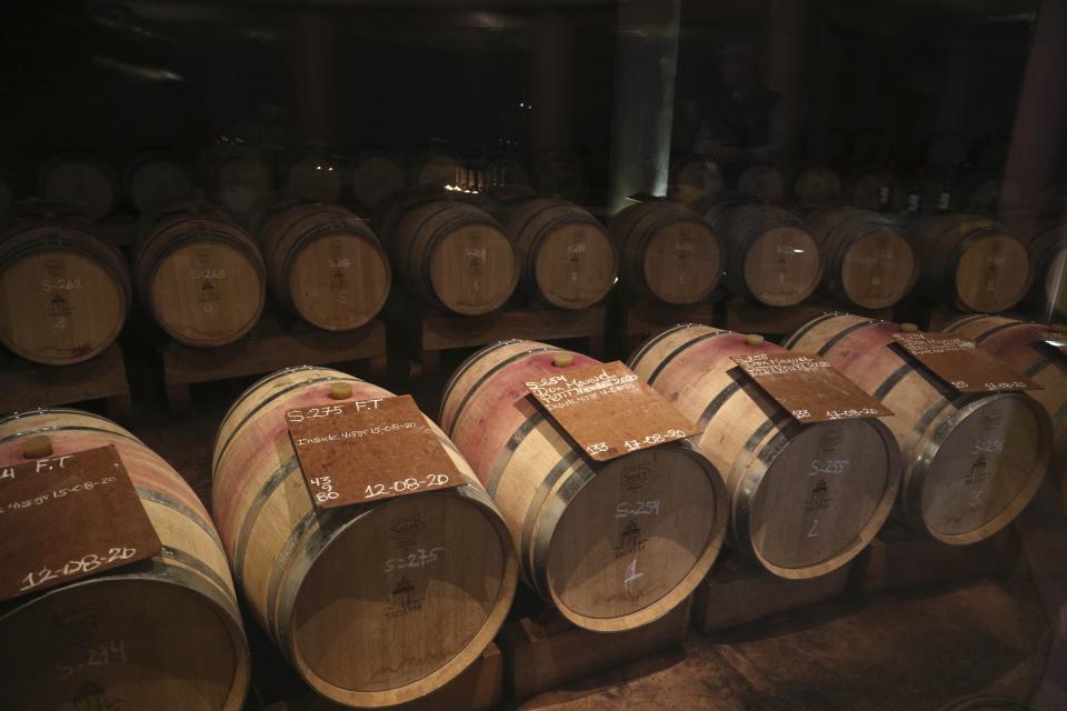 Wine barrels sit at the Tacama vineyard in Ica, Peru, Monday, Sept. 28, 2020. More than 500 Pisco producers have seen their sales collapse by half and thousands of grape growers have had their fields ruined because of the late harvests, because of the strict lockdown implemented to stop COVID-19. (AP Photo/Martin Mejia)