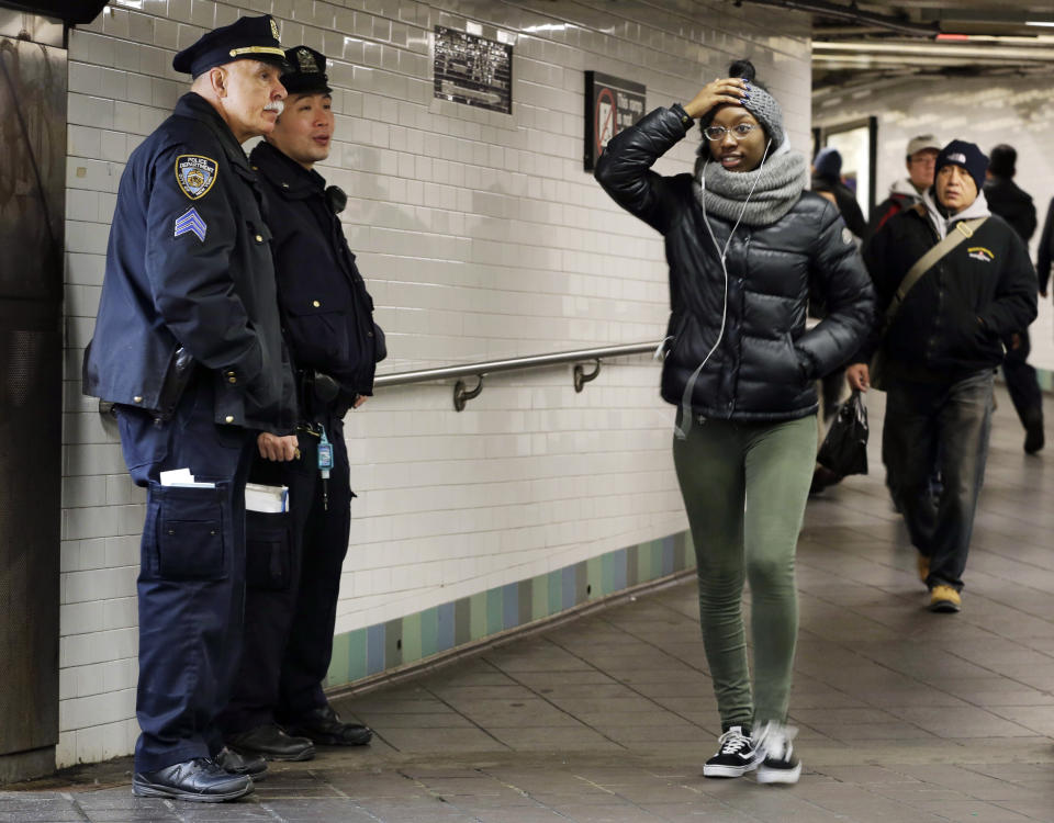 FILE — In this Dec. 12, 2017, file photo, police officers patrol in the passageway connecting New York City's Port Authority bus terminal and the Times Square subway station, near the site of Monday's explosion. Federal prosecutors are seeking a life sentence for Akayed Ullah, a Bangladeshi immigrant, who set off a pipe bomb attached to his chest in New York City's busiest subway station. The request comes after the defendant's lawyers had argued for a 35-year term. (AP Photo/Seth Wenig, File)