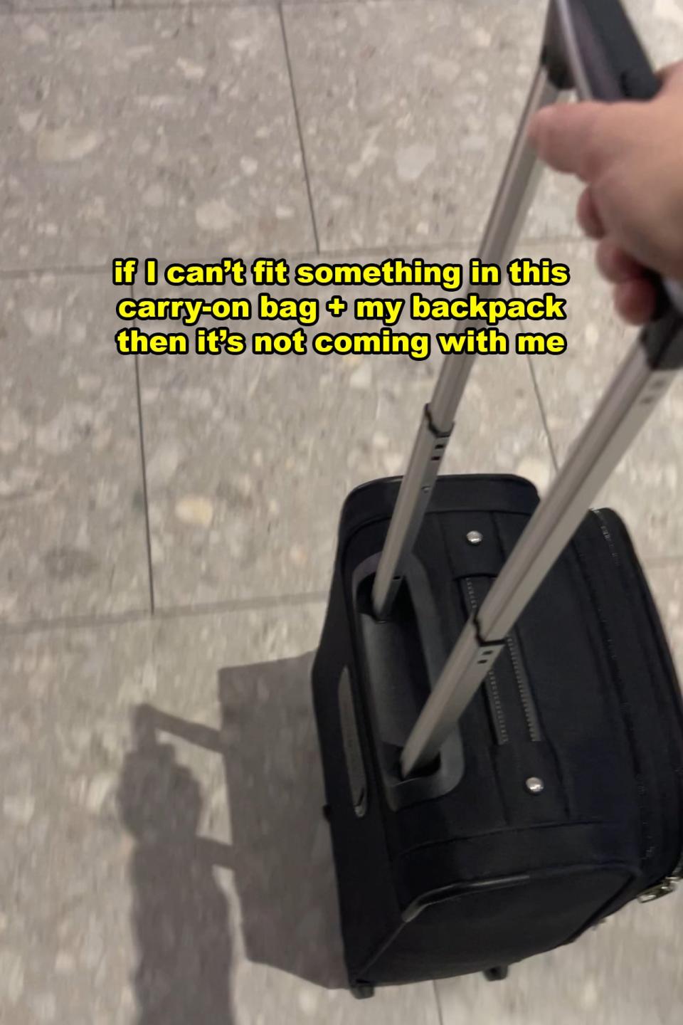 A hand pulls a black carry-on suitcase. Text on the image reads: 