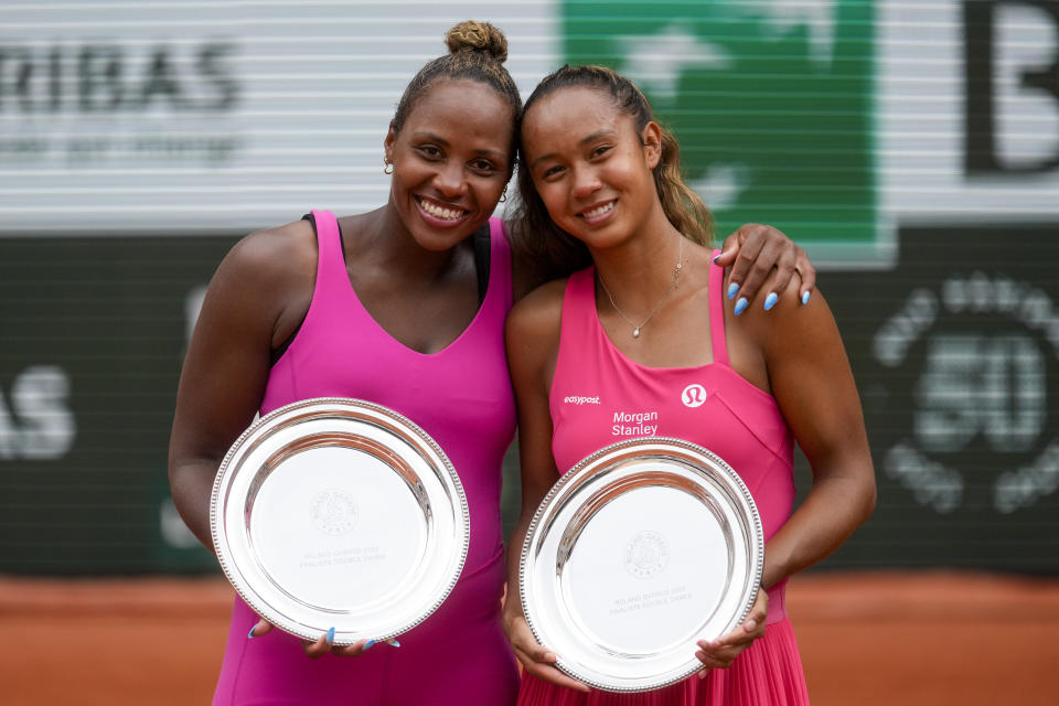 Canada's Leylah Fernandez, right, and Taylor Townsend of the U.S. hold their runner-up trophy after losing the women's doubles final match of the French Open tennis tournament against China's Wang Xinyu and Hsieh Su-Wei of Taiwan at the Roland Garros stadium in Paris, Sunday, June 11, 2023. (AP Photo/Thibault Camus)