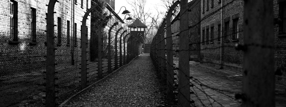 A pathway leading to an observation and security tower between what were electric barbed wire fences inside the former Nazi death camp of Auschwitz I in Oswiecim, Poland, Sunday, Dec. 8, 2019. (AP Photo/Markus Schreiber)