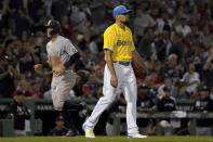 Boston Red Sox starting pitcher Nathan Eovaldi, right, reacts after giving up a three-run home run to New York Yankees designated hitter Giancarlo Stanton (not shown) as Aaron Judge, left, rounds the bases to score during the third inning of a baseball game at Fenway Park, Friday, Sept. 24, 2021, in Boston. (AP Photo/Mary Schwalm)