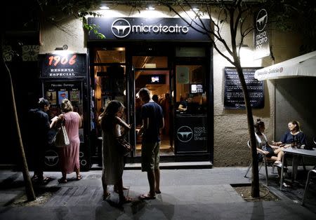 People are seen in front of Microteatro Por Dinero (Microtheatre for money) in central Madrid, Spain September 2, 2016. Picture taken September 2, 2016. REUTERS/Andrea Comas