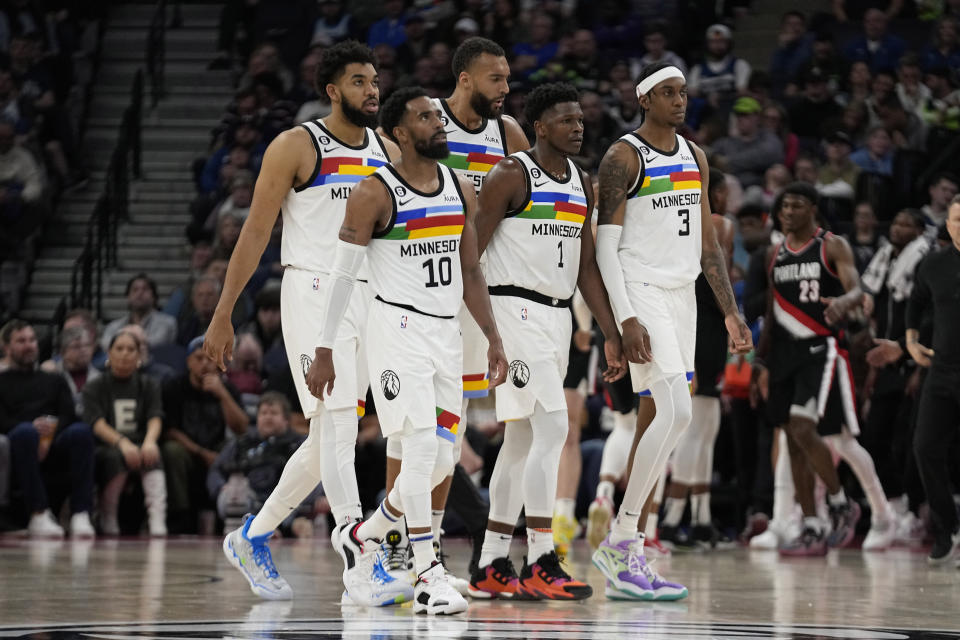From left to right, Minnesota Timberwolves center Karl-Anthony Towns, guard Mike Conley, center Rudy Gobert, guard Anthony Edwards (1) and forward Jaden McDaniels (3) walk to the bench during a timeout break in the second half of an NBA basketball game against the Portland Trail Blazers, Sunday, April 2, 2023, in Minneapolis. (AP Photo/Abbie Parr)