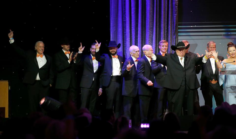 Former Oklahoma State University Pistol Pete mascots stand on stage during the 2022 Hall of Great Westerns for Frank "Pistol Pete" Eaton during the Western Heritage Awards at the National Cowboy & Western Heritage Museum in Oklahoma City, Saturday, April, 9, 2022.  