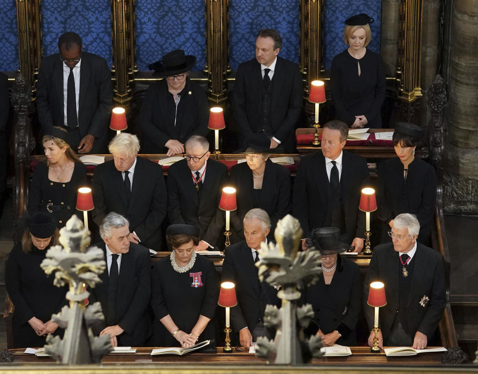 From top row from left, Chancellor of the Exchequer Kwasi Kwarteng, Deputy Prime Minister Dr Therese Coffey, Hugh O'Leary, Prime Minister Liz Truss, middle row left to right, Carrie Johnson, former Prime Minister Boris Johnson, Philip May, former Prime Minister Theresa May, former Prime Minister David Cameron, Samantha Cameron, bottom row left to right, Sarah Brown, former Prime Minister Gordon Brown, Cherie Blair, former Prime Minister Tony Blair, Lady Norma Major and former Prime Minister John Major, attend the State Funeral of Queen Elizabeth II, held at Westminster Abbey, London, Monday, Sept. 19, 2022. (Gareth Fuller/Pool Photo via AP)