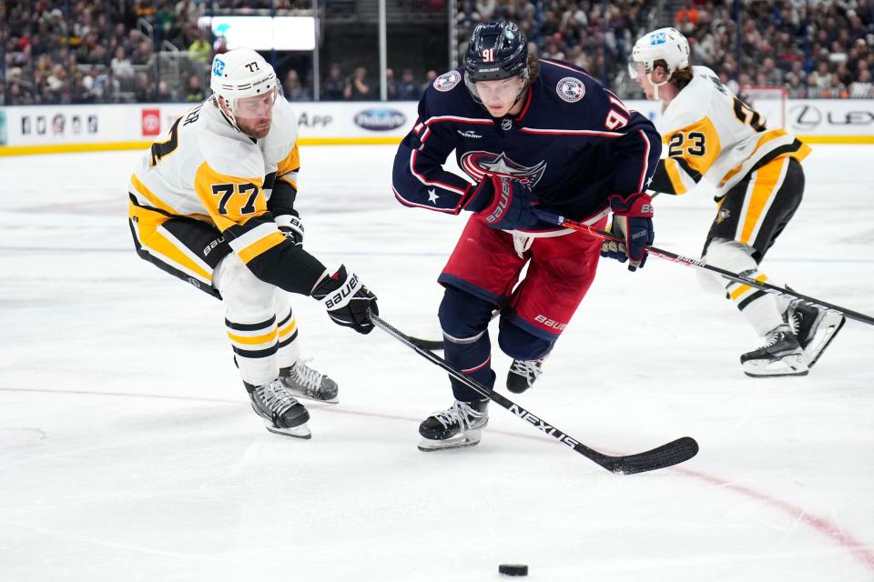 Oct 22, 2022; Columbus, Ohio, USA;  Columbus Blue Jackets forward Kent Johnson (91) contests the puck with Pittsburgh Penguins forward Jeff Carter (77) during the third period of the hockey game between the Columbus Blue Jackets and the Pittsburgh Penguins at Nationwide Arena. Mandatory Credit: Joseph Scheller-The Columbus Dispatch