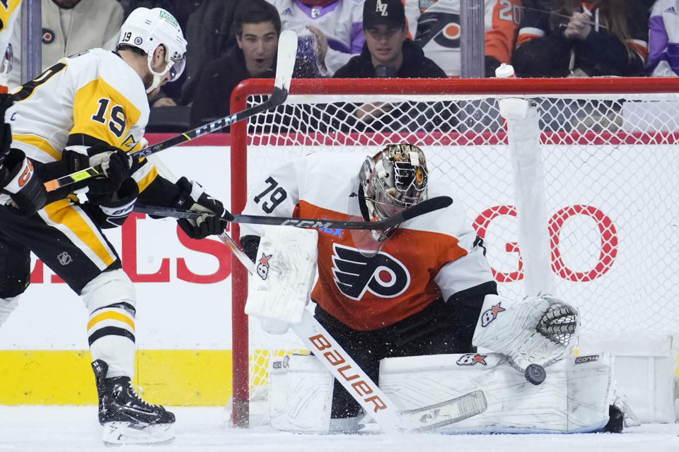 Philadelphia Flyers' Carter Hart, right, blocks a shot by Pittsburgh Penguins' Reilly Smith during the second period of an NHL hockey game, Monday, Dec. 4, 2023, in Philadelphia. (AP Photo/Matt Slocum)