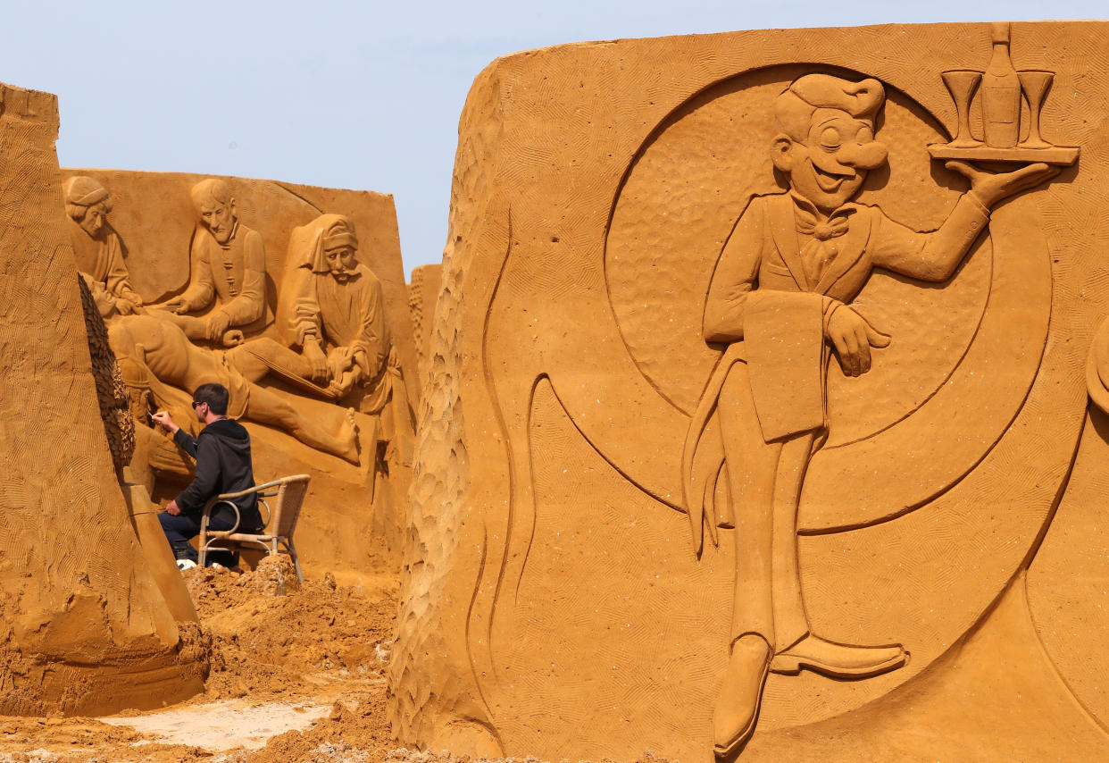 A sand carver works on a sculpture during the Sand Sculpture Festival "Dreams" in Ostend, Belgium June 18, 2019. (Photo: Yves Herman/Reuters)