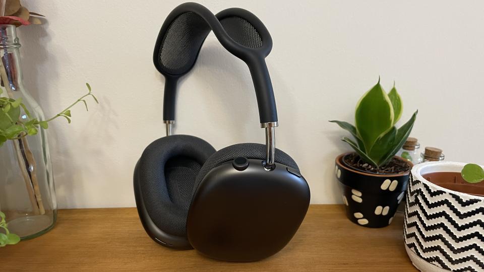 Apple AirPods Max on a desktop next to plants